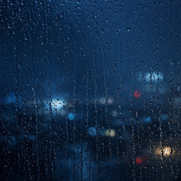 Rain on Window at Night Sad DP – Raindrops running down a window glass at night with blurred city lights behind, melancholic blue tones, photog… (Sad DPS)